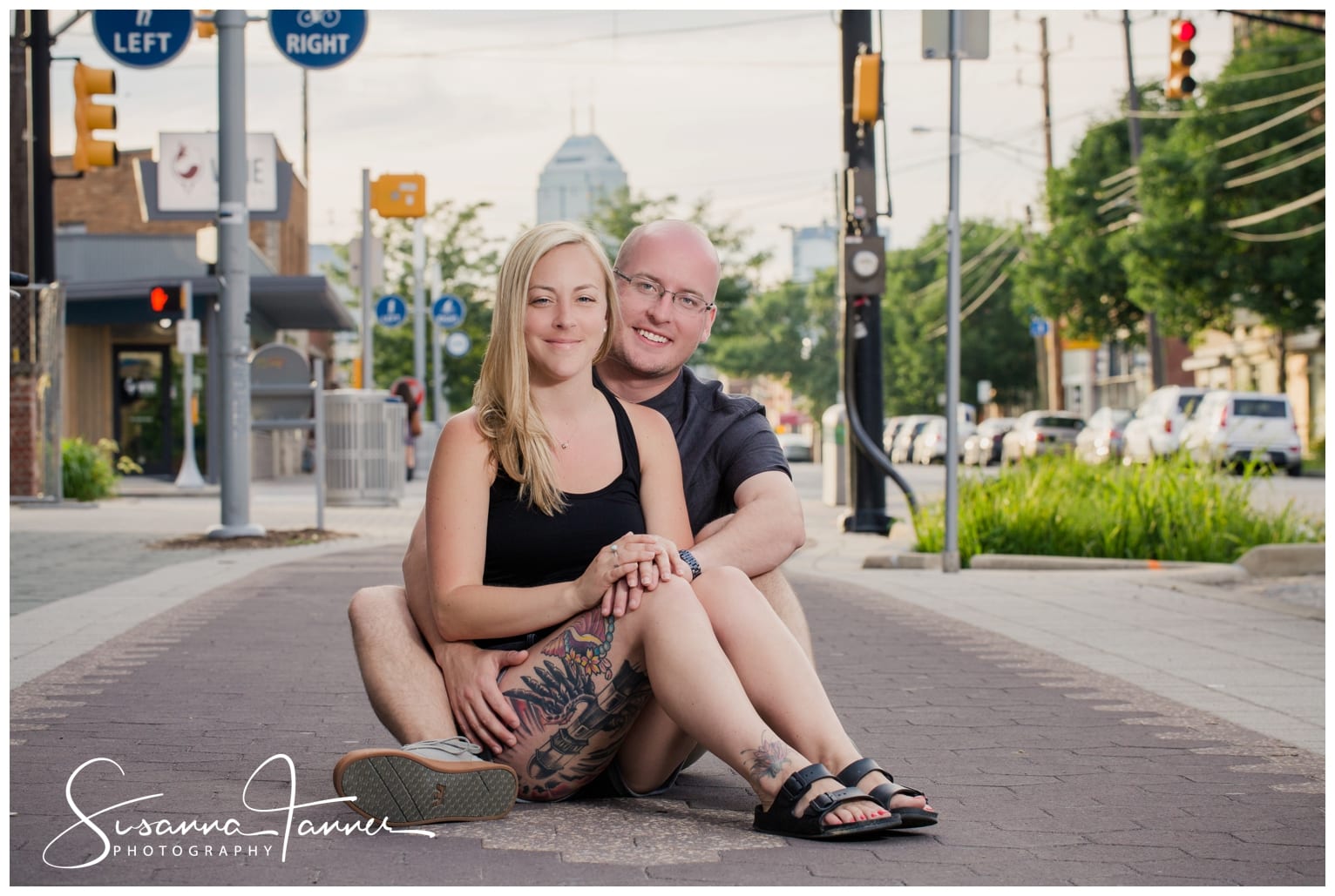 Fountain Square Indianapolis Photography Engagement Session couple sitting on city sidewalk