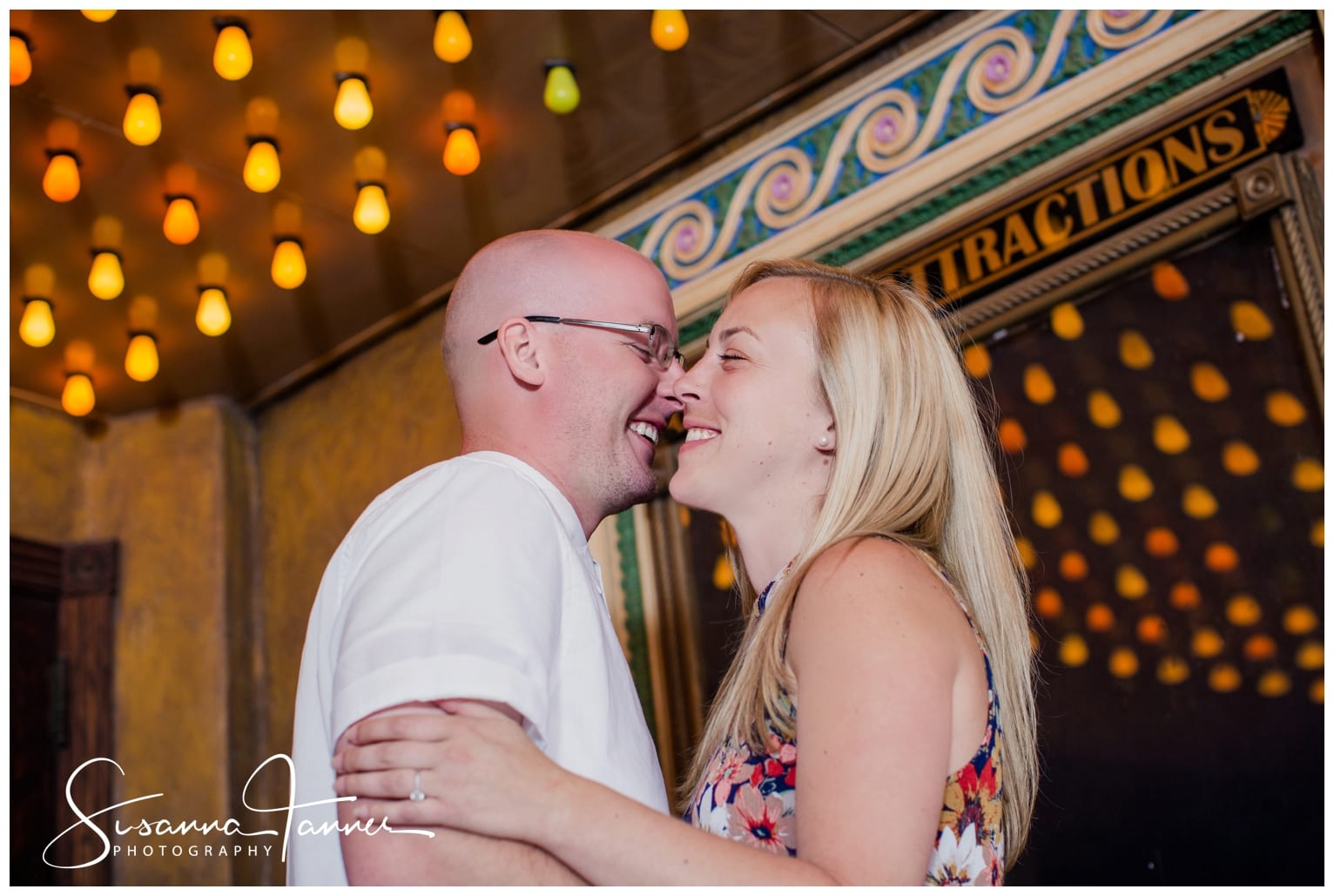 Fountain Square Indianapolis Photography Engagement Session couple standing inside the Fountain Square theatre entrande