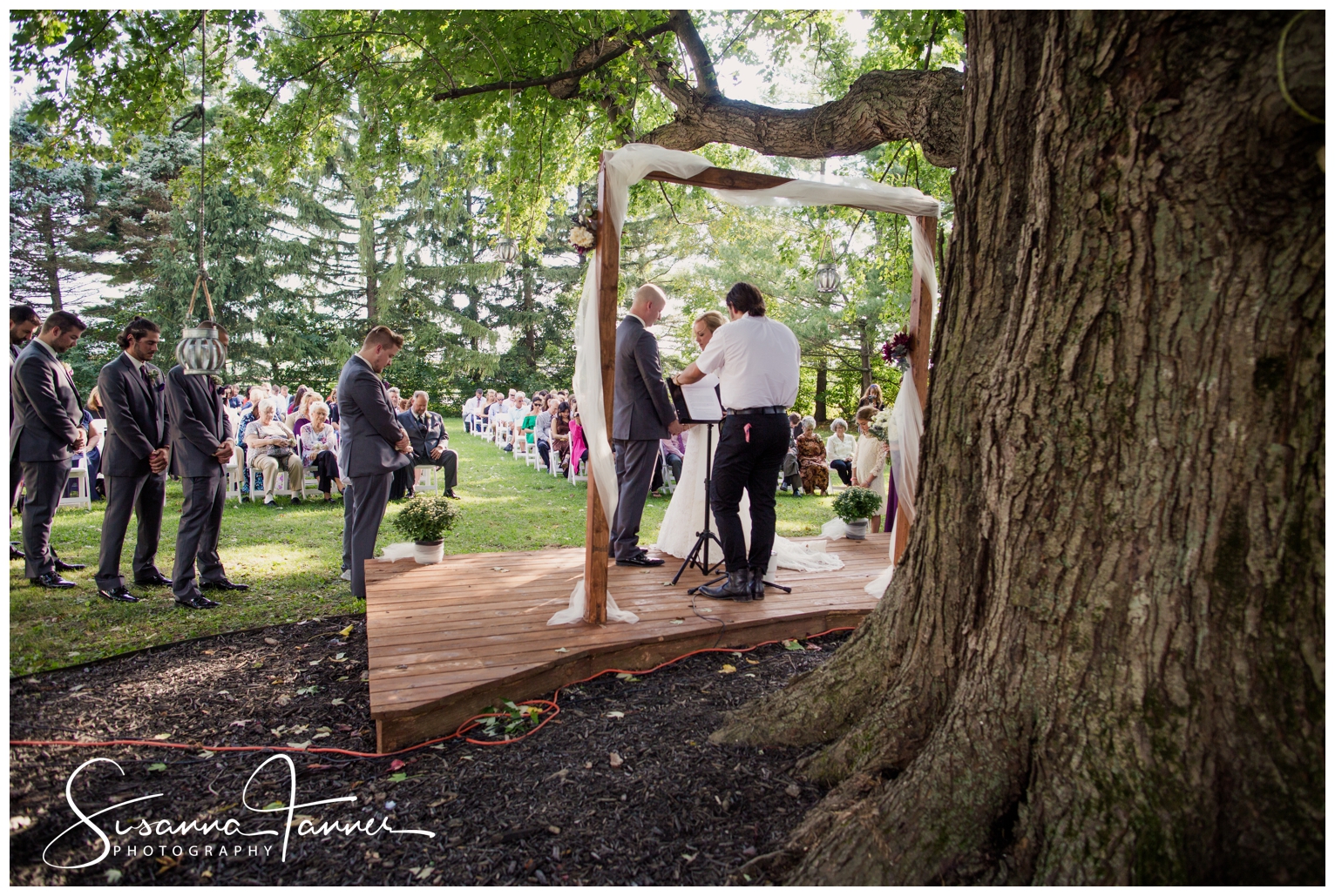 Indianapolis Outdoor Wedding, bride and groom saying vows with large tree trunk in foreground