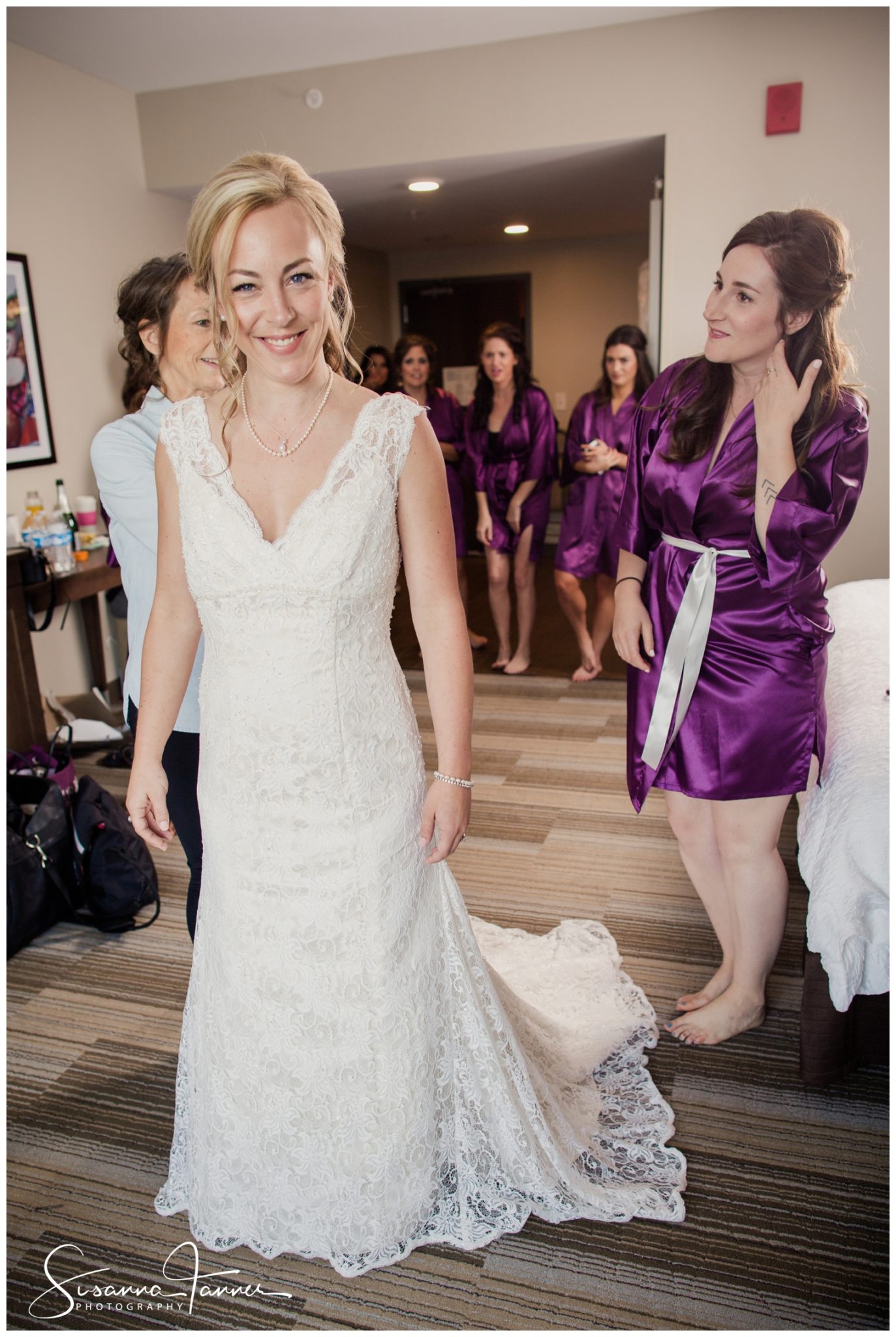 Indianapolis Outdoor Wedding, bride smiling while having her wedding dress zipped