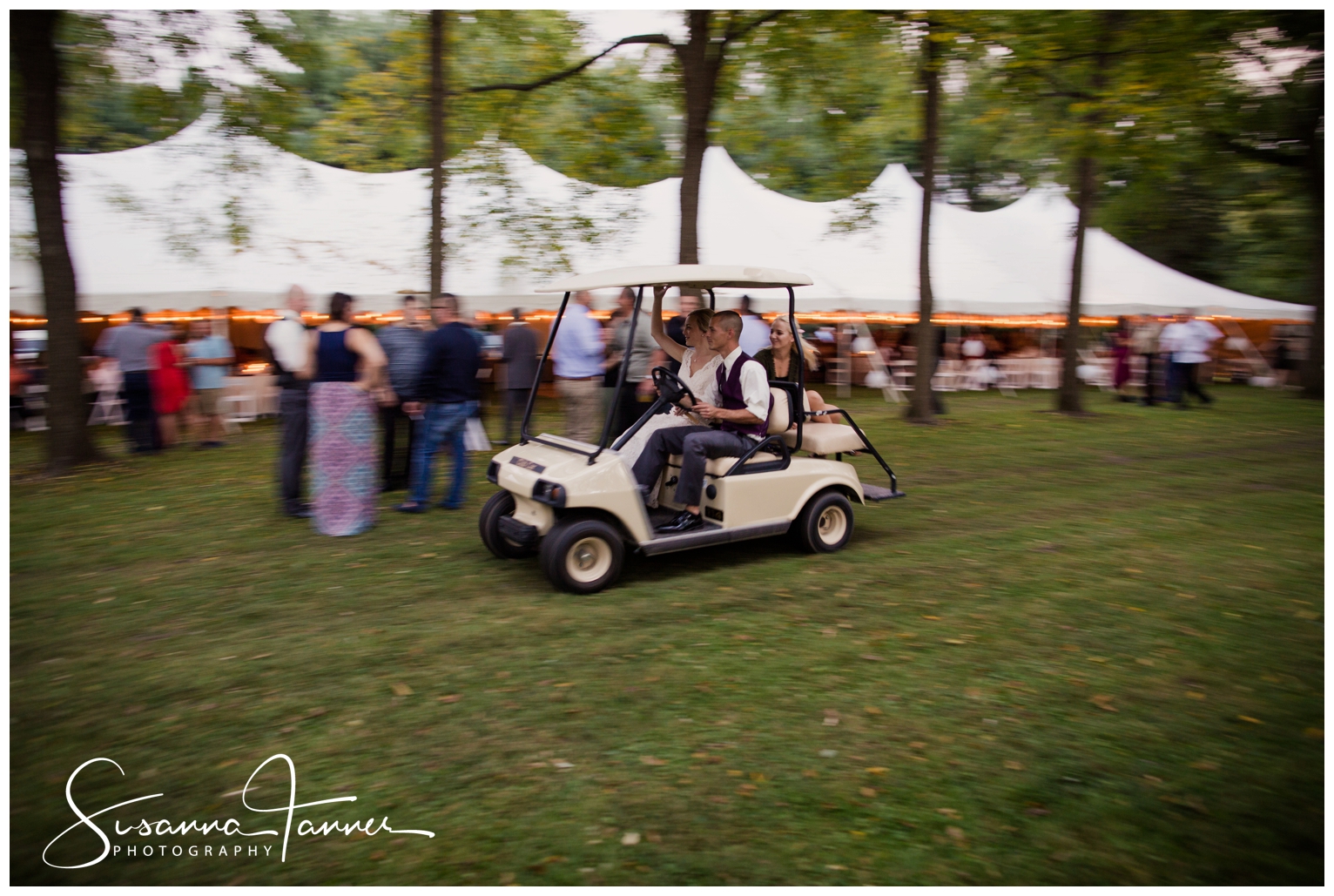 Indianapolis Outdoor Wedding, bride riding in golf cart in front of reception tent