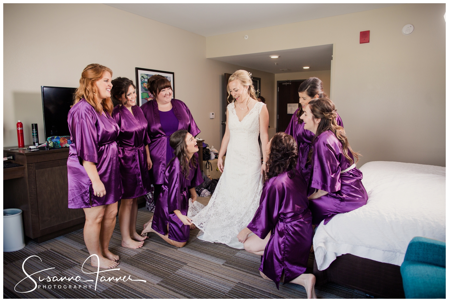 Indianapolis Outdoor Wedding, bride in dressing room with her bridesmaids wearing wedding dress