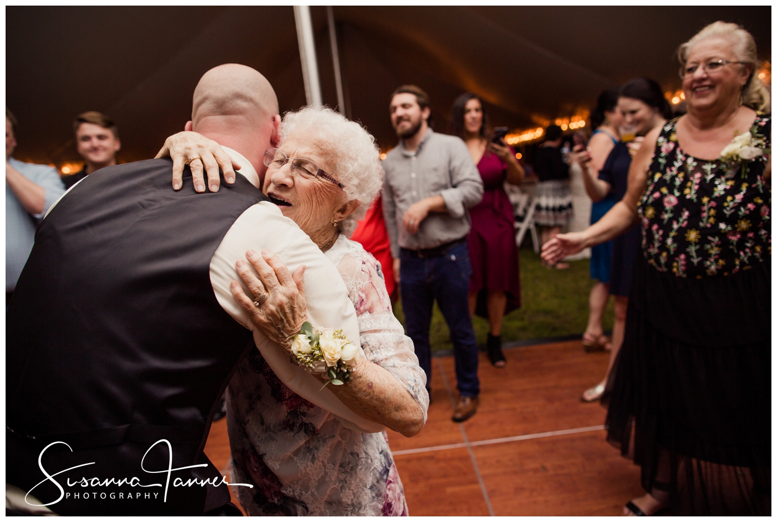 Indianapolis Outdoor Wedding, groom hugging elderly grandma on dance floor. Her face looks radiant