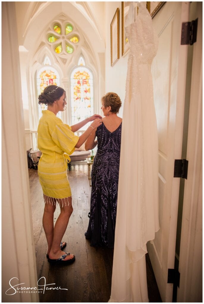 The Transept, Cincinnati OH wedding, bride helping her soon to be mother-in-law by adjusting the shoulder of her dress. 