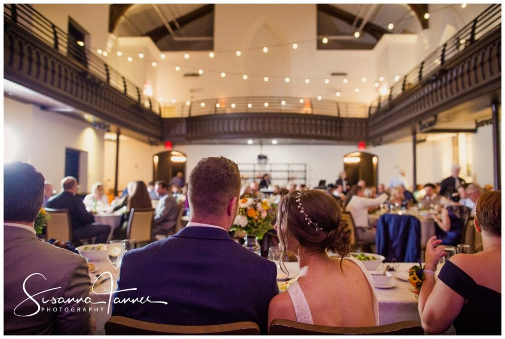  The Transept, Cincinnati Ohio wedding, wide shot of couple looking out over their wedding reception. 