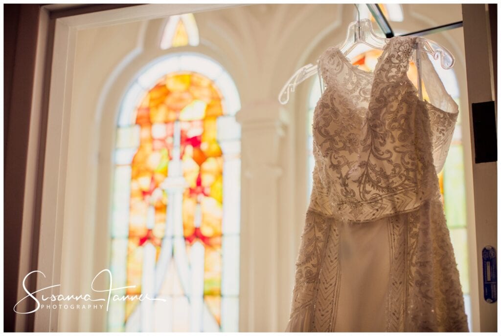The Transept, Cincinnati OH wedding, Bridal dress hanging in front of stained glass window