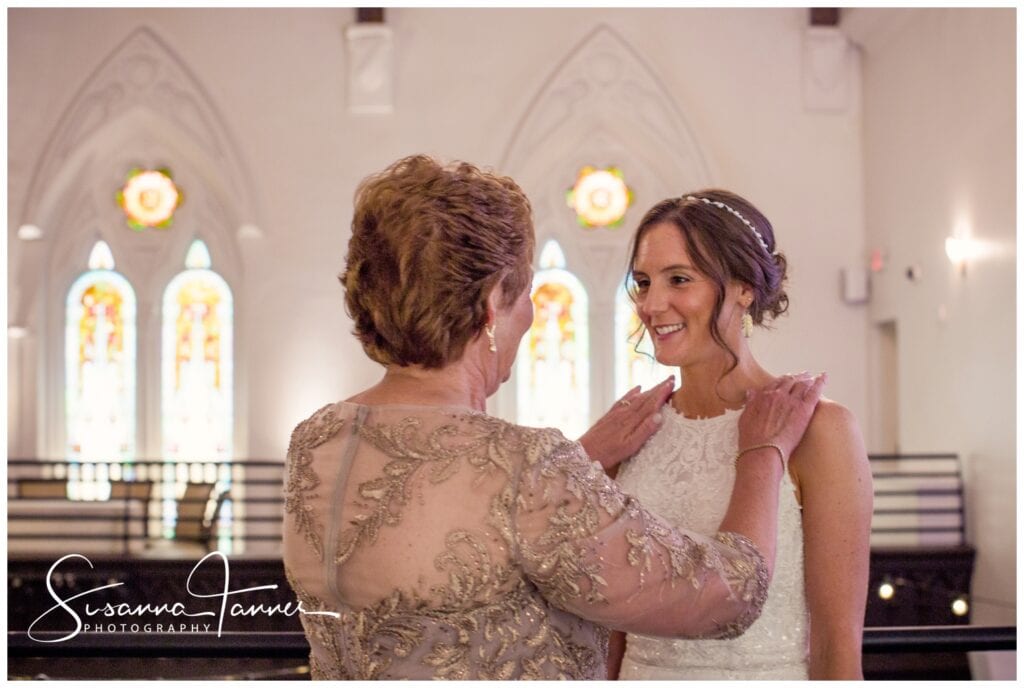 The Transept, Cincinnati Ohio wedding, Mother of bride with her hands on brides shoulders. Bride is smiling at her. 