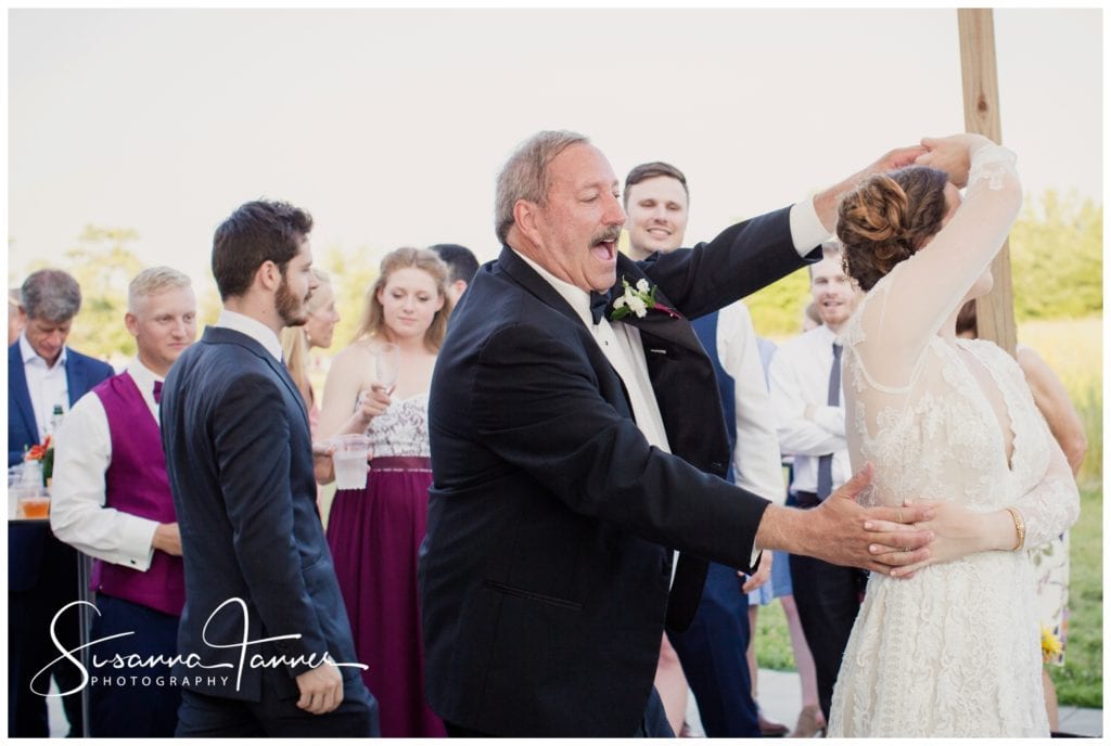 Richmond Indiana, dad twirling bride during danc