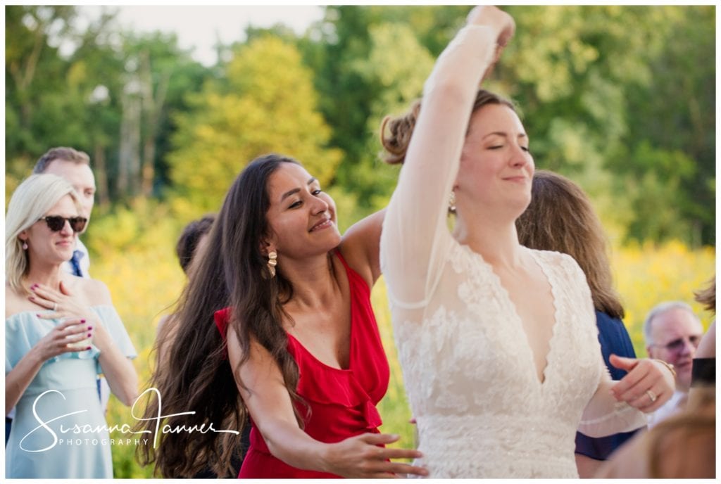bride dancing with a female college friend