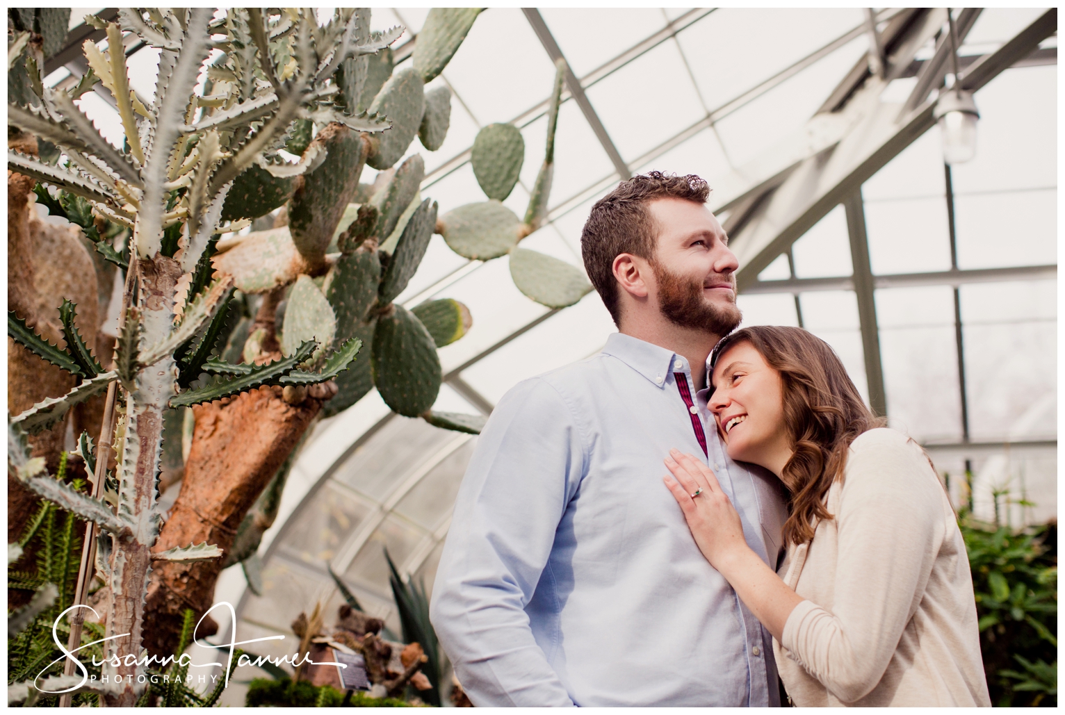 Cincinnati Krohn Conservatory Engagement Photography, woman leaning head on man's chest while they stand near a tall cactus
