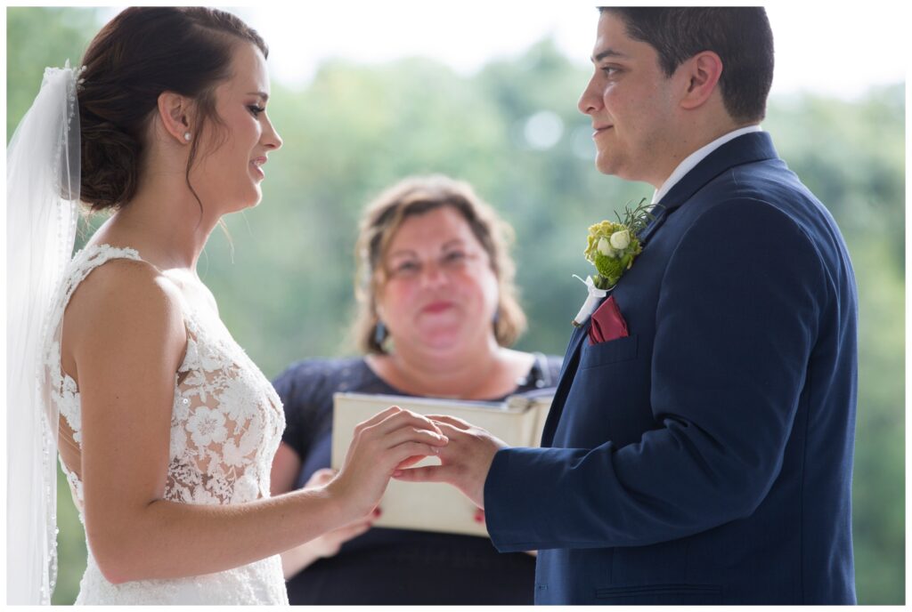 The Wilds Wedding Venue, Bloomington, Indiana, bride slipping on groom's wedding ring