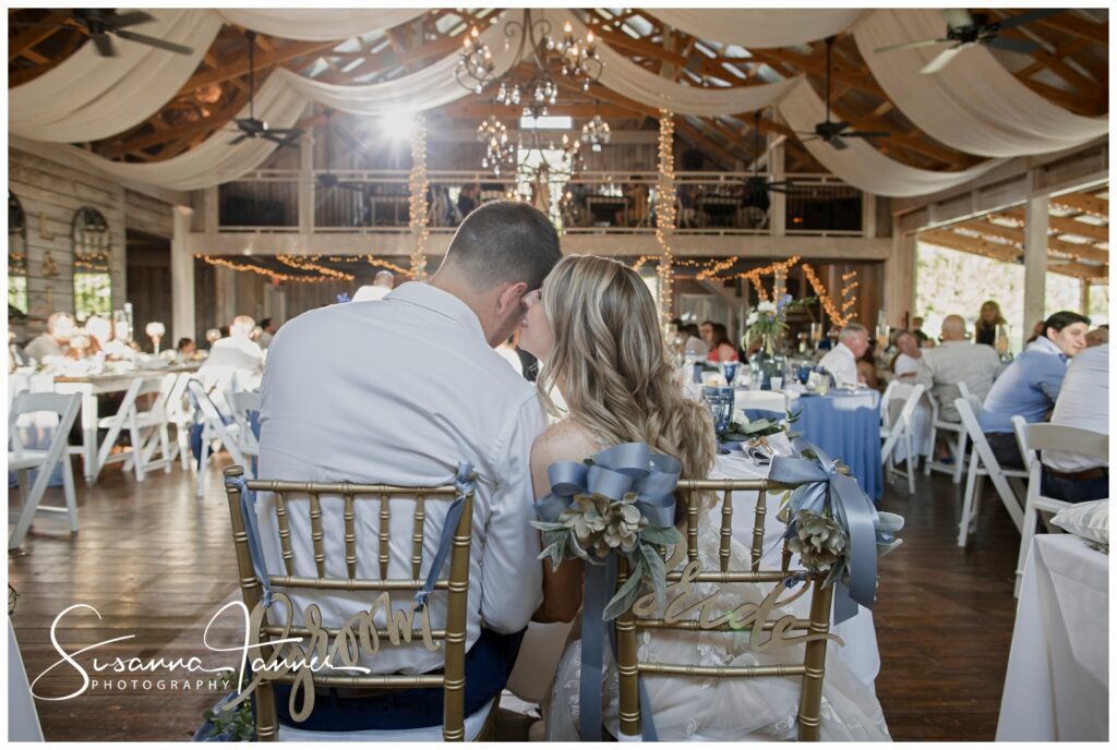 Laurel Mill barn wedding, bride whispering in groom's ear during reception