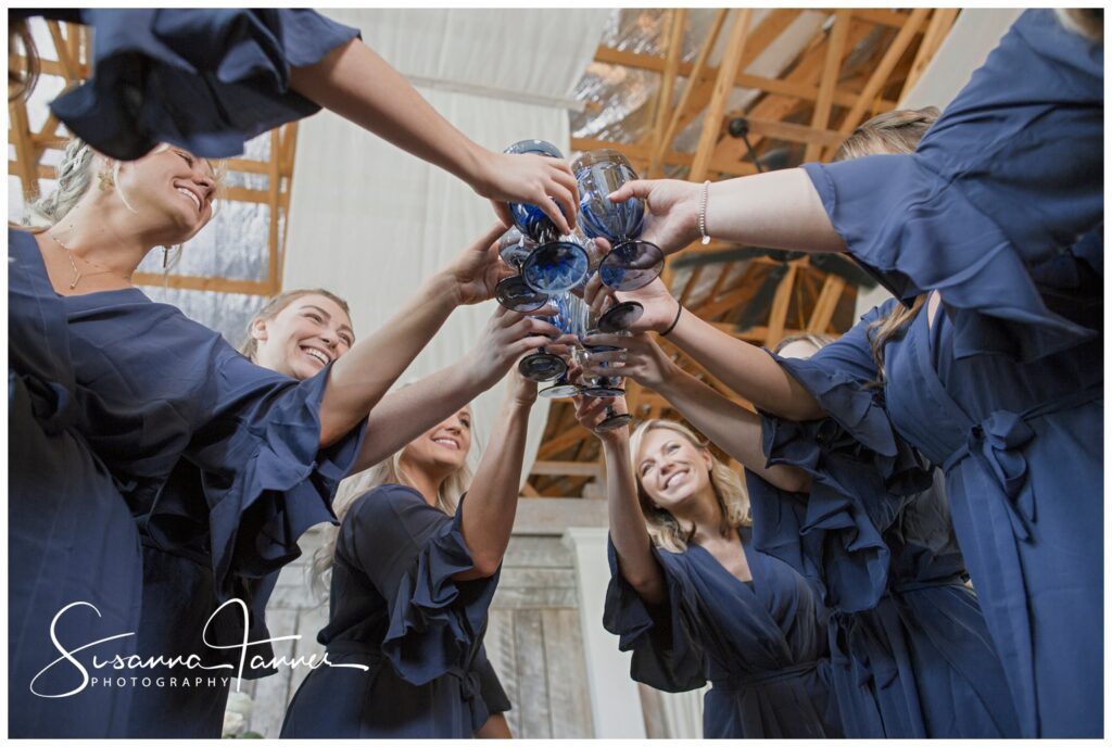 underneath view of bridesmaids toasting in a circle