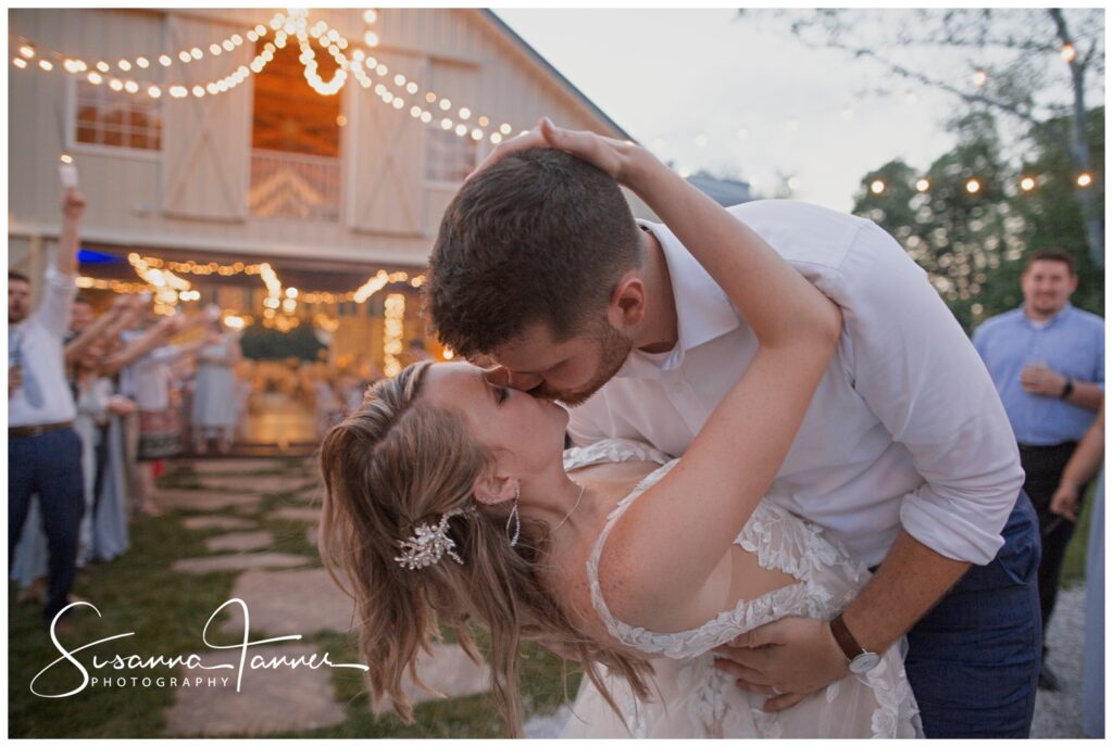 Laurel Mill barn wedding, Bloomington, IN, bride and groom run through sparkler send off, groom kisses bride in a dip