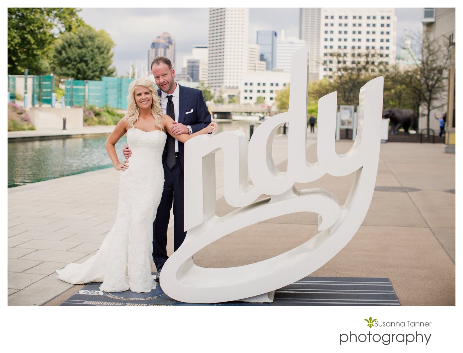 Indiana State Museum wedding photography, bride and groom on canal with NDY sculpture