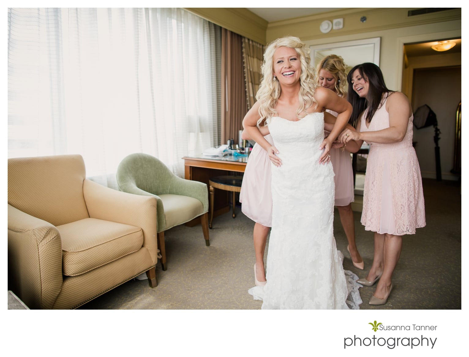 Indiana State Museum wedding photography, bride laughing while wedding dress is being zipped