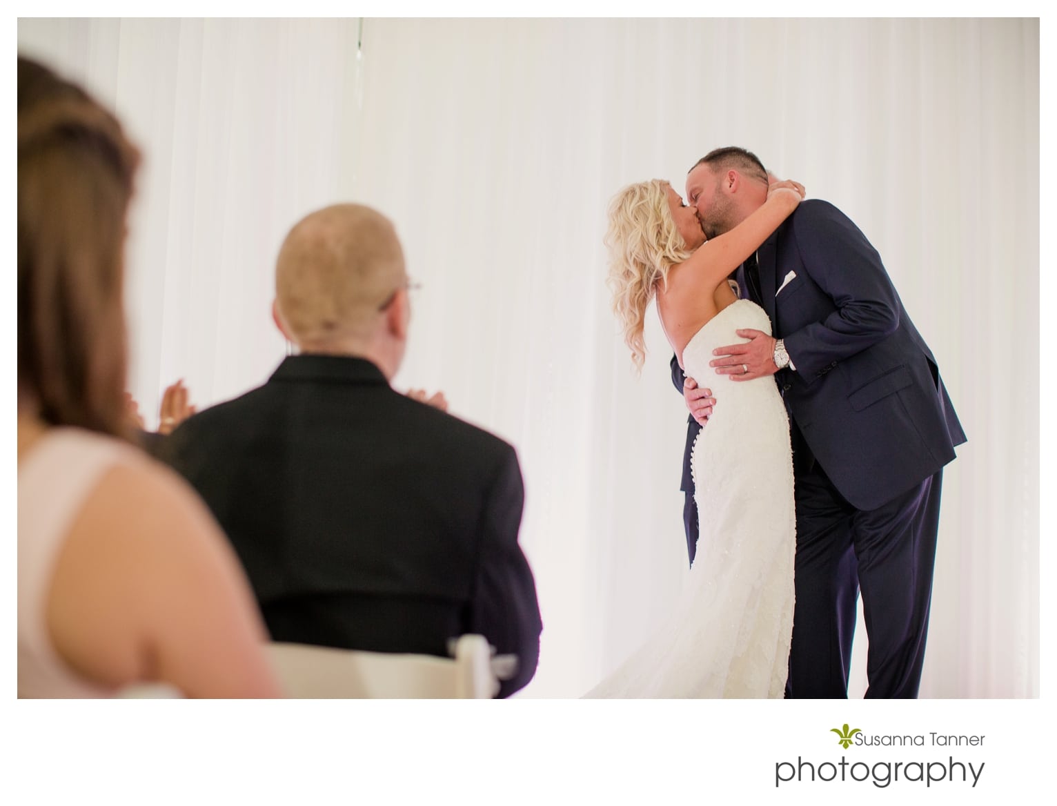 Indiana State Museum wedding photography, bride and groom kiss while parents look on