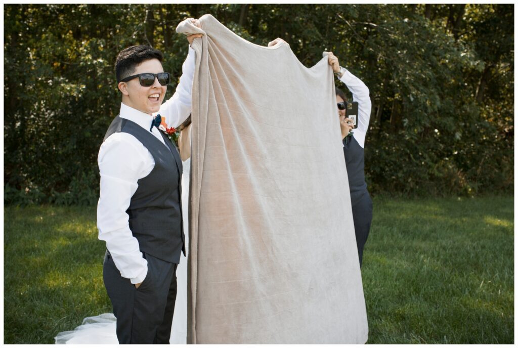 Gay wedding, west central Ohio, first look, groomspeople holding up blanket so couple don't see each other