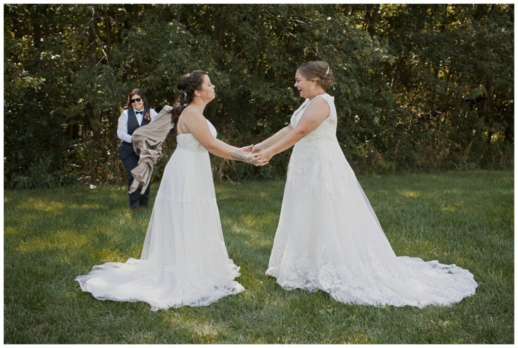 Gay wedding, west central Ohio, first look, both brides see each other and smile while holding hands