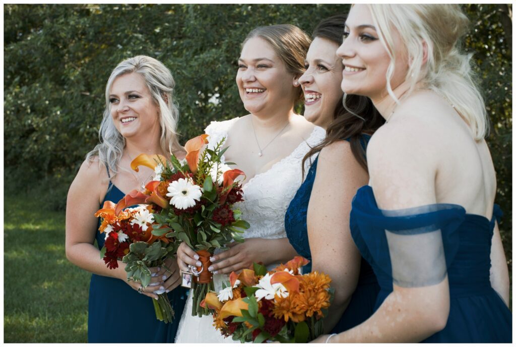 gay wedding, bride #2 with bridal party holding flower bouquets