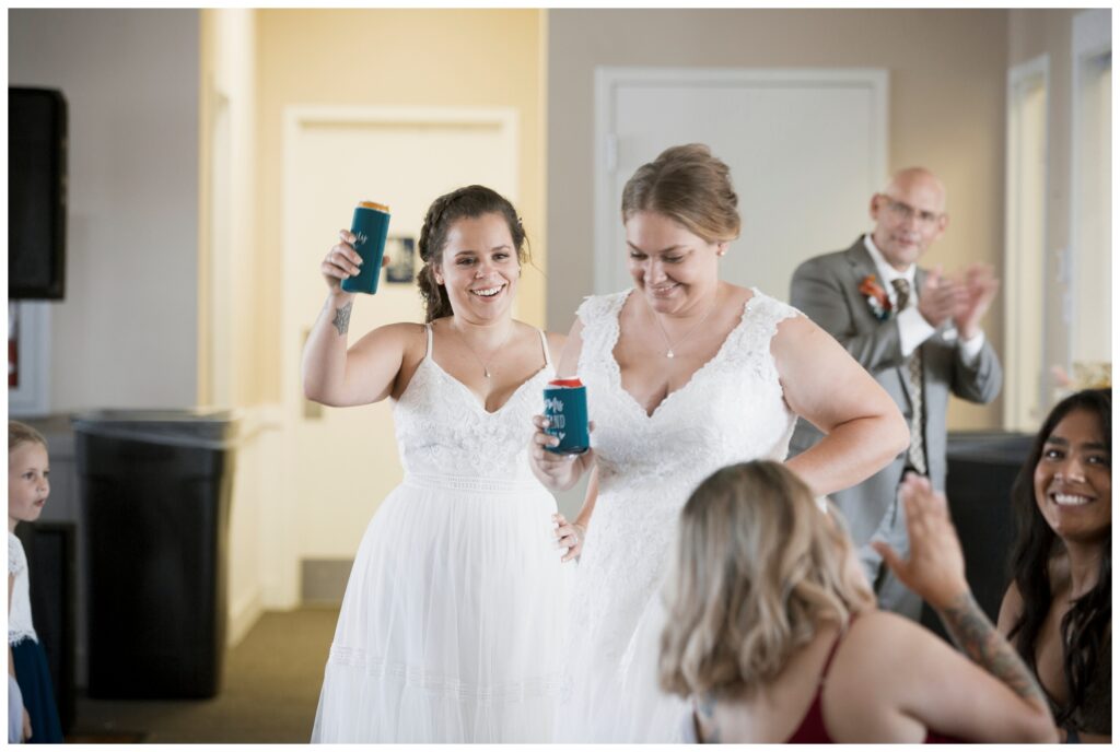 gay wedding, west central Ohio, couple is announced as they enter their reception. Toasting with drinks.